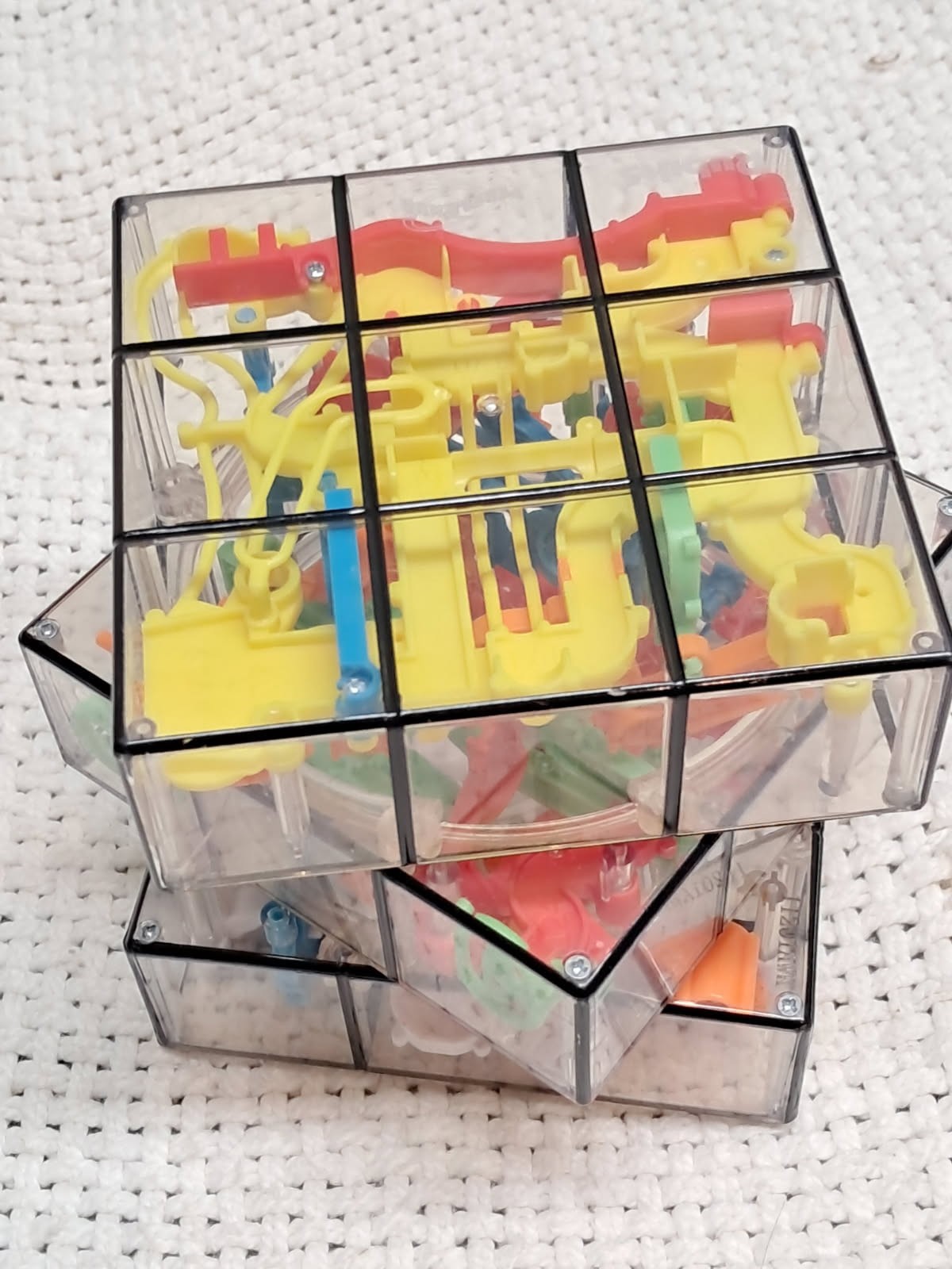 see thru cubed maze, 9 sided, multicolored, very hard to do, brain teaser