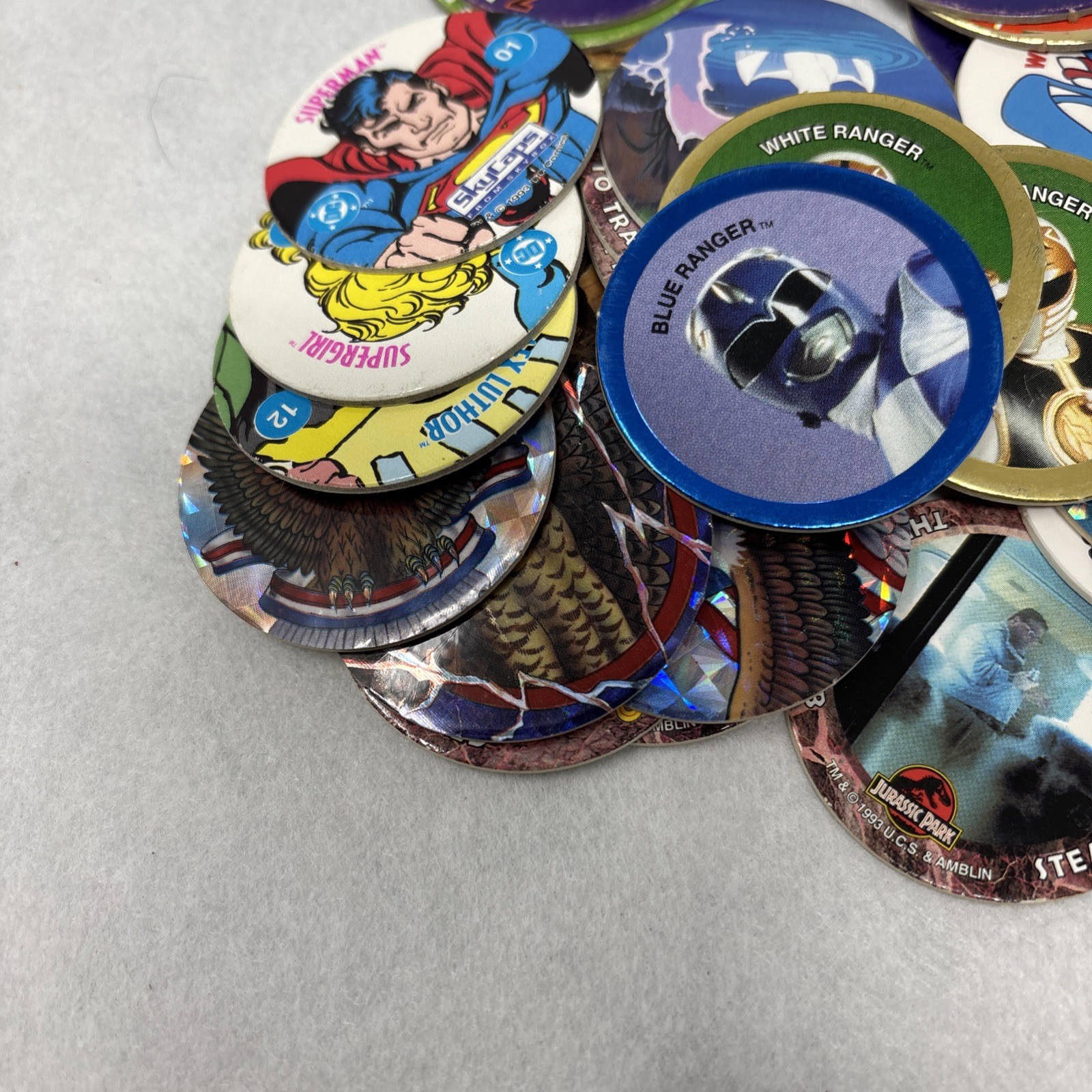 Vintage Pogs Lot Various 1990s Power Rangers, Jurassic Park, DC Comics w/ Tube