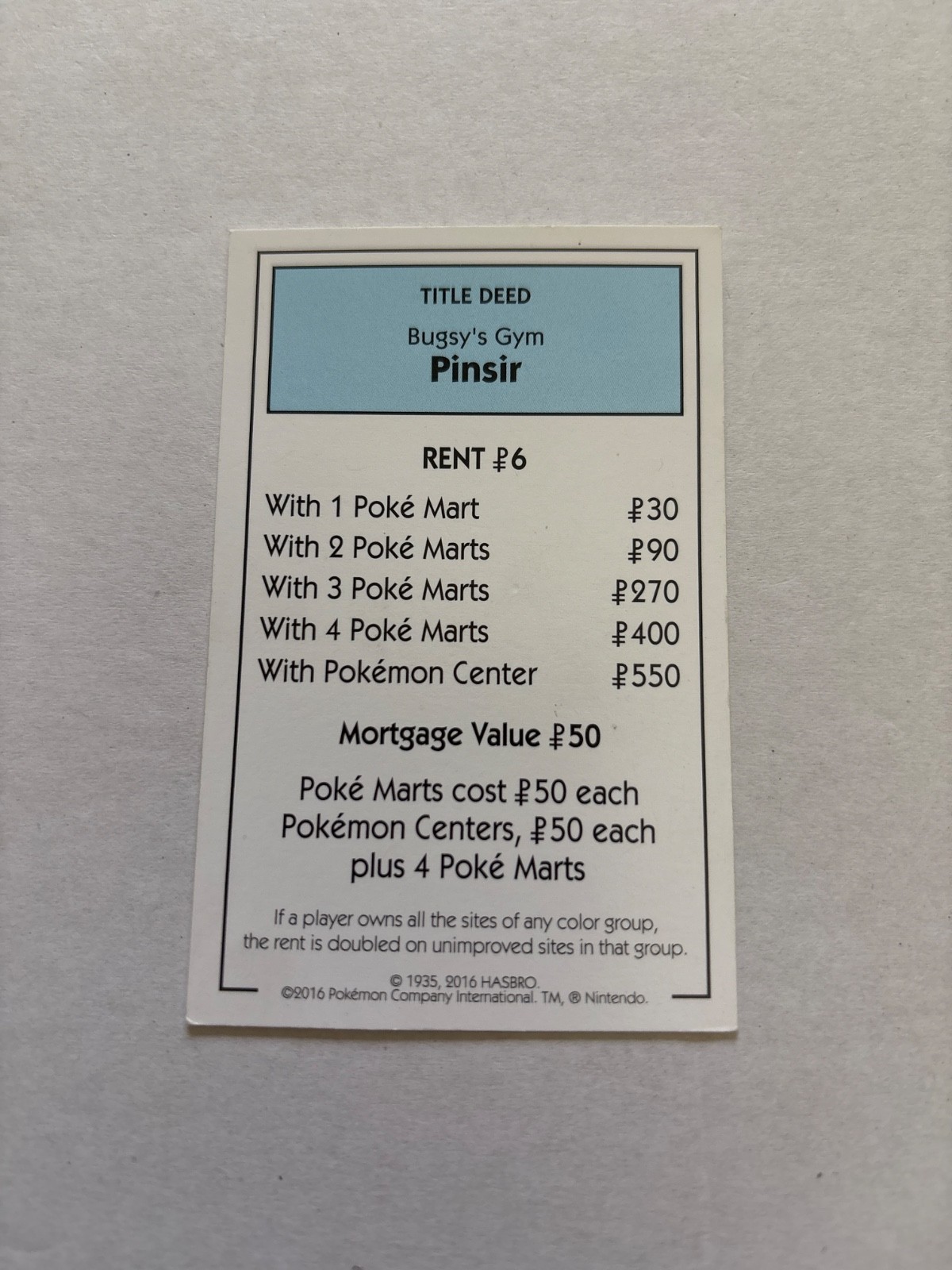 2016 Monopoly Pokémon Title Deed Card Game Piece Light Blue Bugsy Gym Pinsir