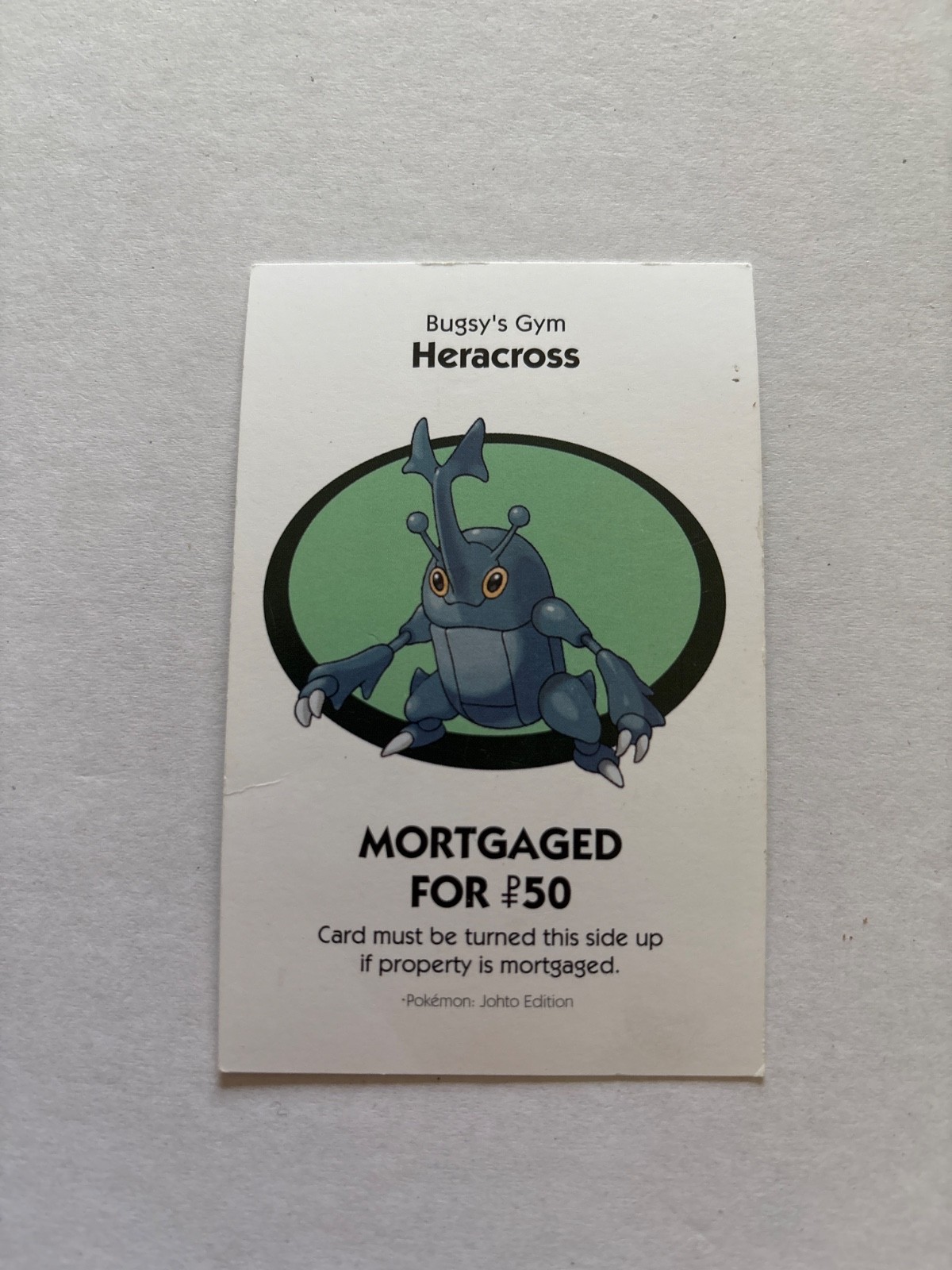 2016 Monopoly Pokémon Title Deed Card Game Piece Light Blue Bugsy Gym Heracross