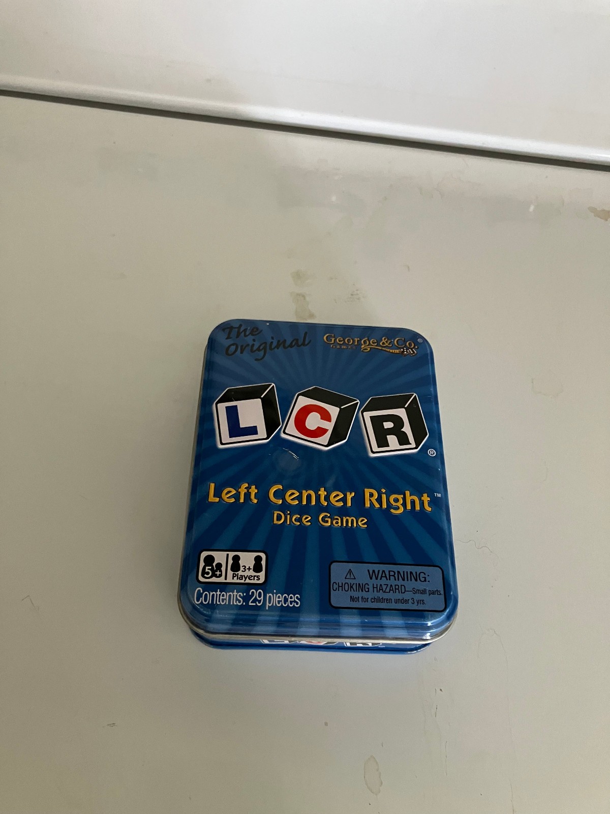 LCR® Left Center Right™ Dice Game – Blue Tin