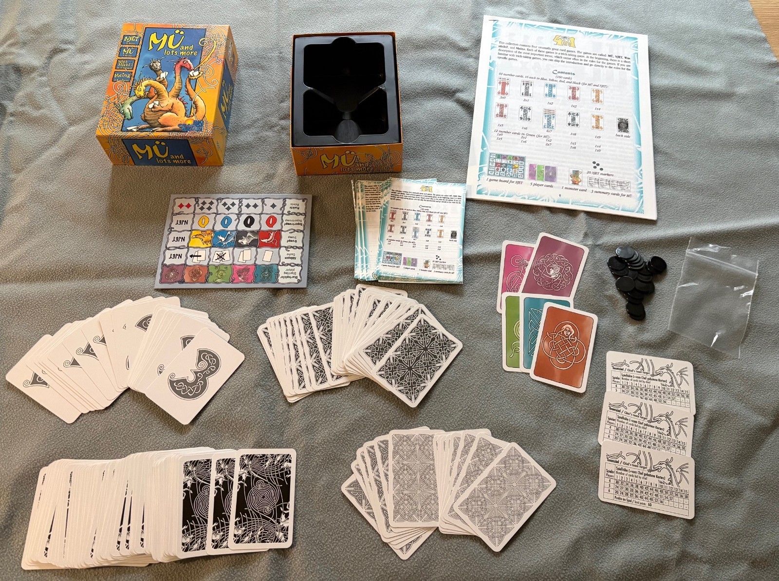 Mu and Lots More Complete except rules are a printout; card game Njet Was Sticht