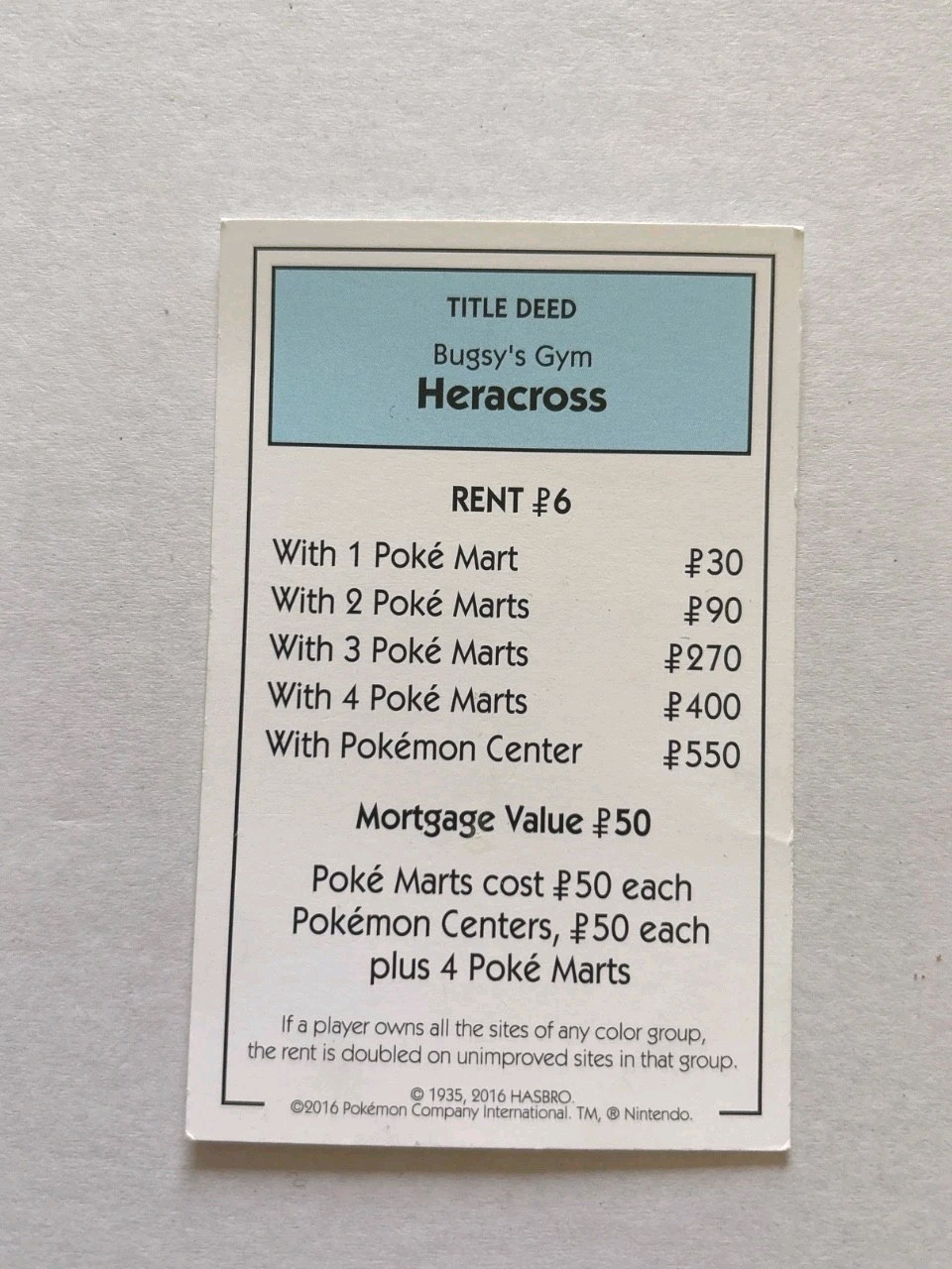 2016 Monopoly Pokémon Title Deed Card Game Piece Light Blue Bugsy Gym Heracross