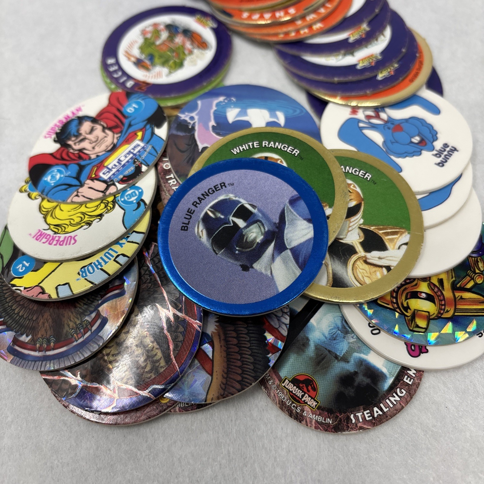 Vintage Pogs Lot Various 1990s Power Rangers, Jurassic Park, DC Comics w/ Tube
