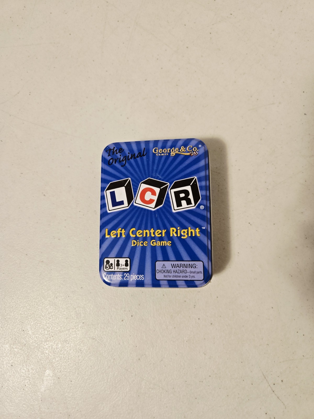 The Original LCR Left Center Right Dice Game Blue Tin (George & Co, 2010)