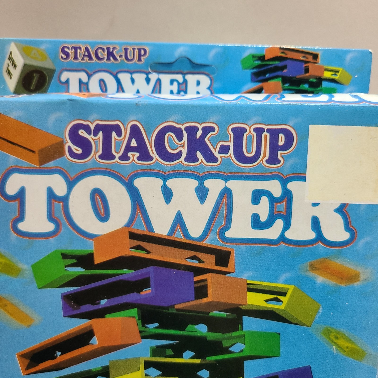Stack Up Tower with 45 Colored Plastic Blocks and One Dice.
