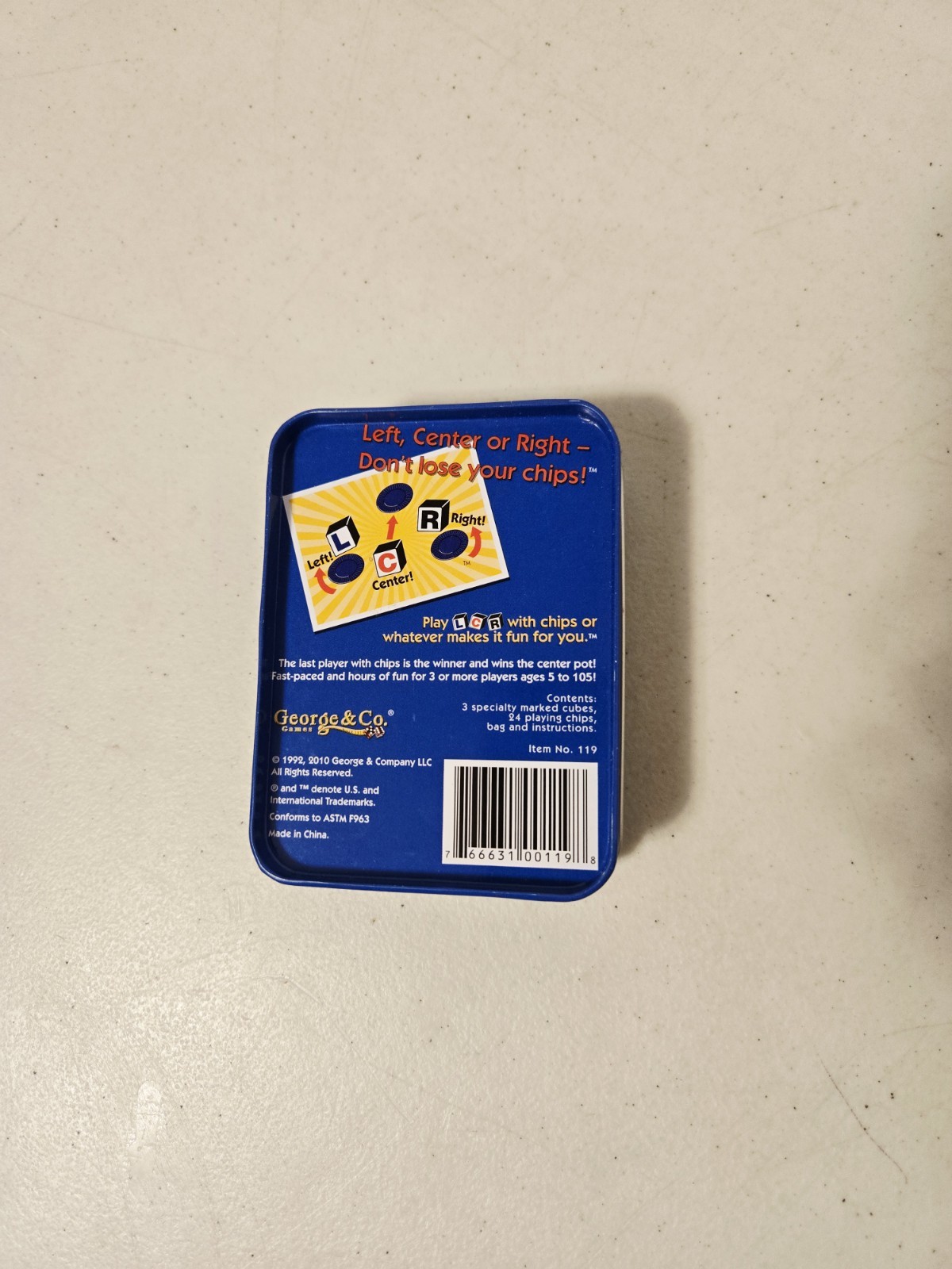 The Original LCR Left Center Right Dice Game Blue Tin (George & Co, 2010)