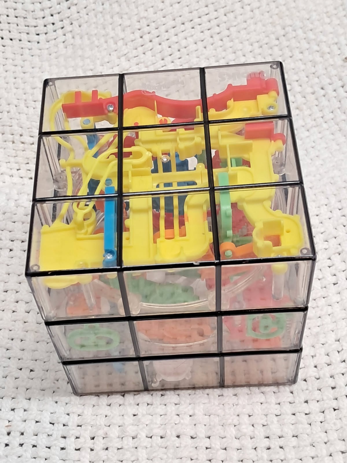 see thru cubed maze, 9 sided, multicolored, very hard to do, brain teaser