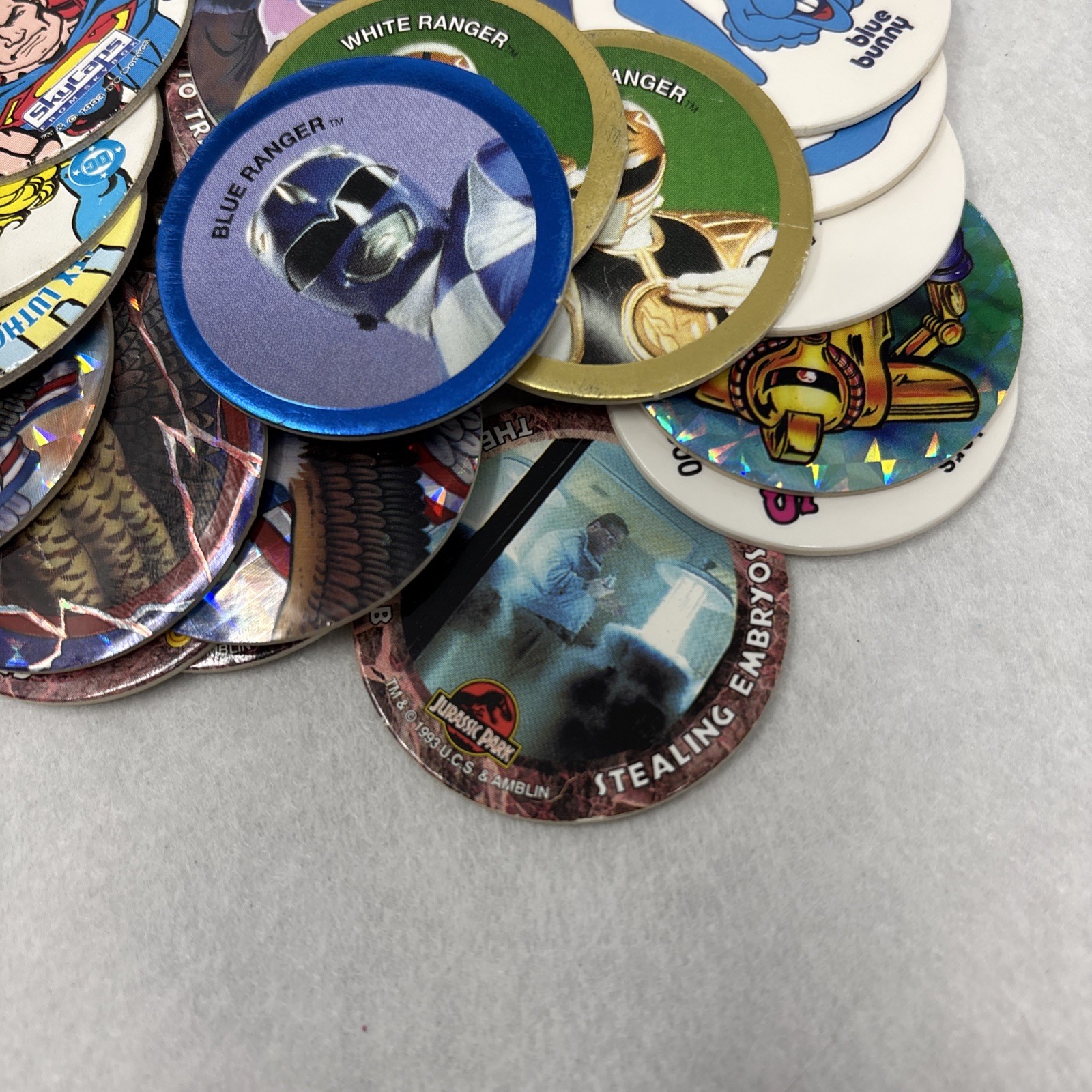 Vintage Pogs Lot Various 1990s Power Rangers, Jurassic Park, DC Comics w/ Tube
