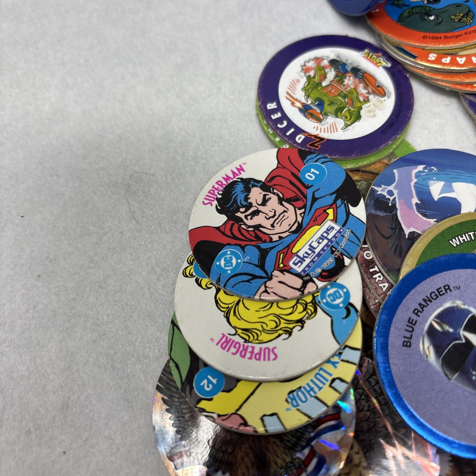Vintage Pogs Lot Various 1990s Power Rangers, Jurassic Park, DC Comics w/ Tube