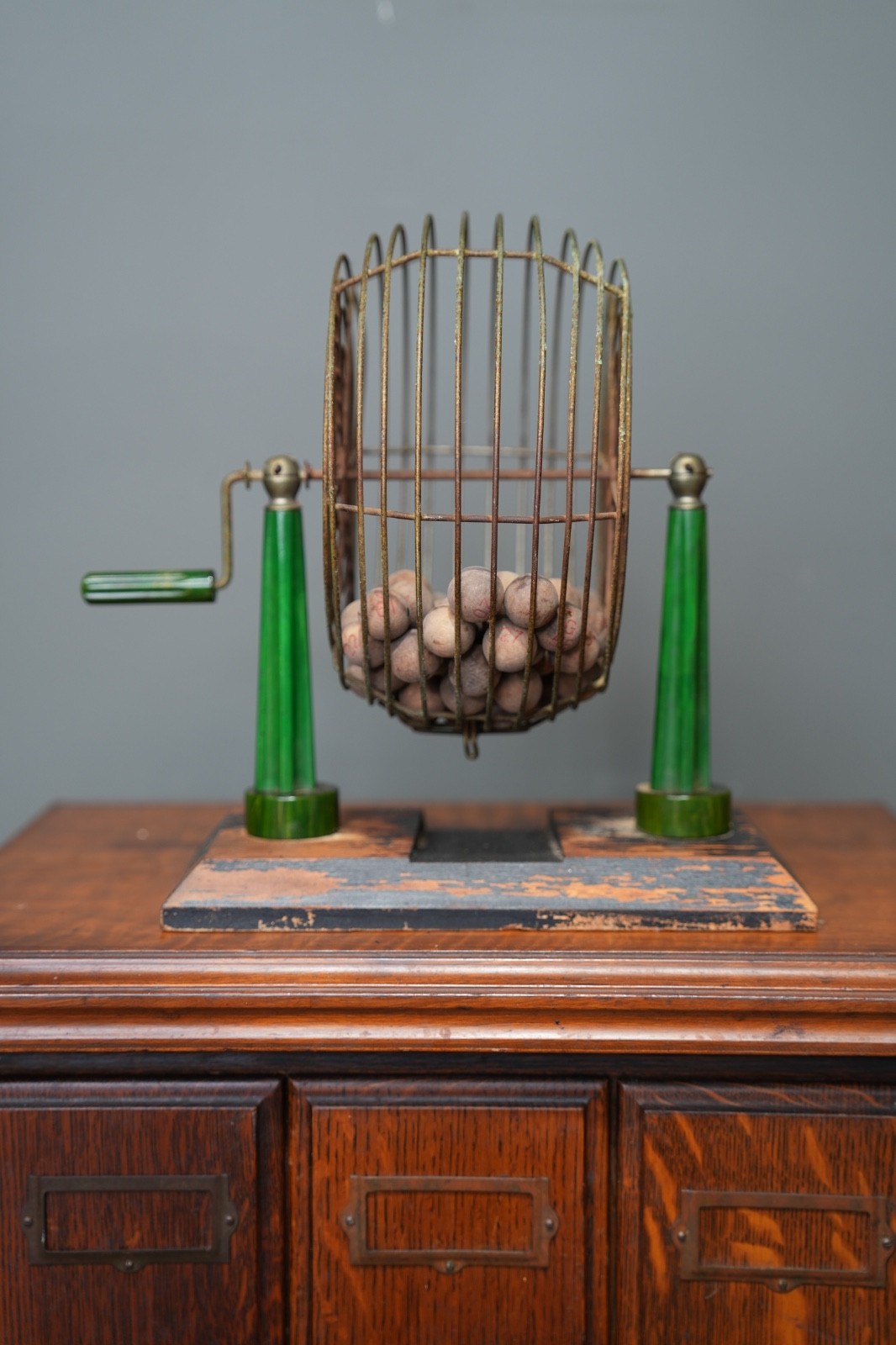 Vintage Metal Bingo Cage Green Bakelite Tower Pillars handle w/ wooden balls