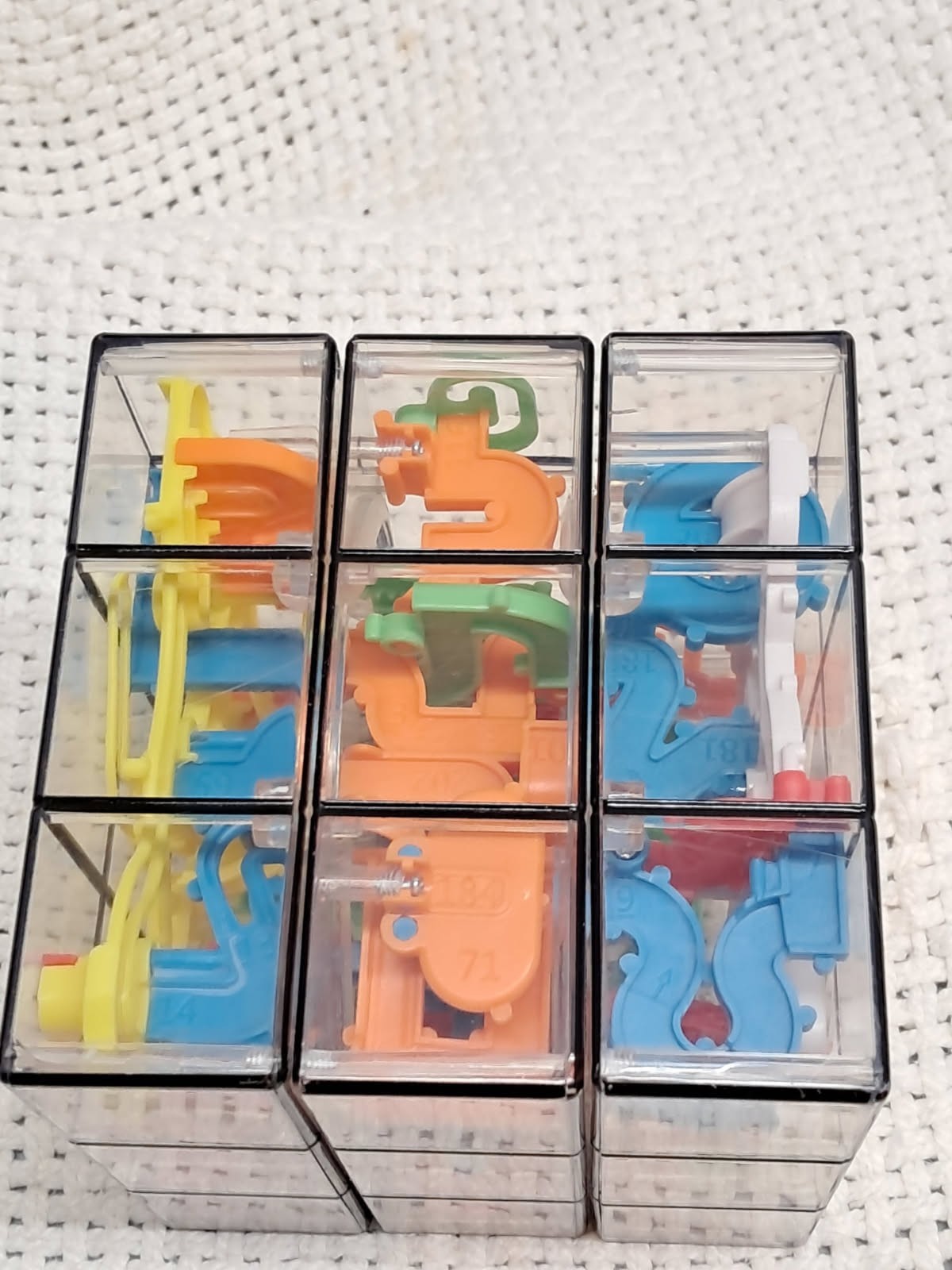 see thru cubed maze, 9 sided, multicolored, very hard to do, brain teaser